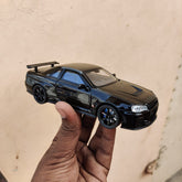 Black die-cast model of a Nissan Skyline GT-R R34 1:32 Scale Openable Doors & Light, Music Toy