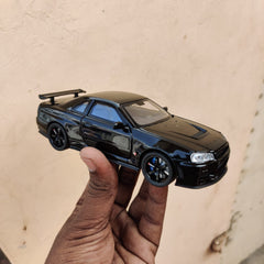 Black die-cast model of a Nissan Skyline GT-R R34 1:32 Scale Openable Doors & Light, Music Toy