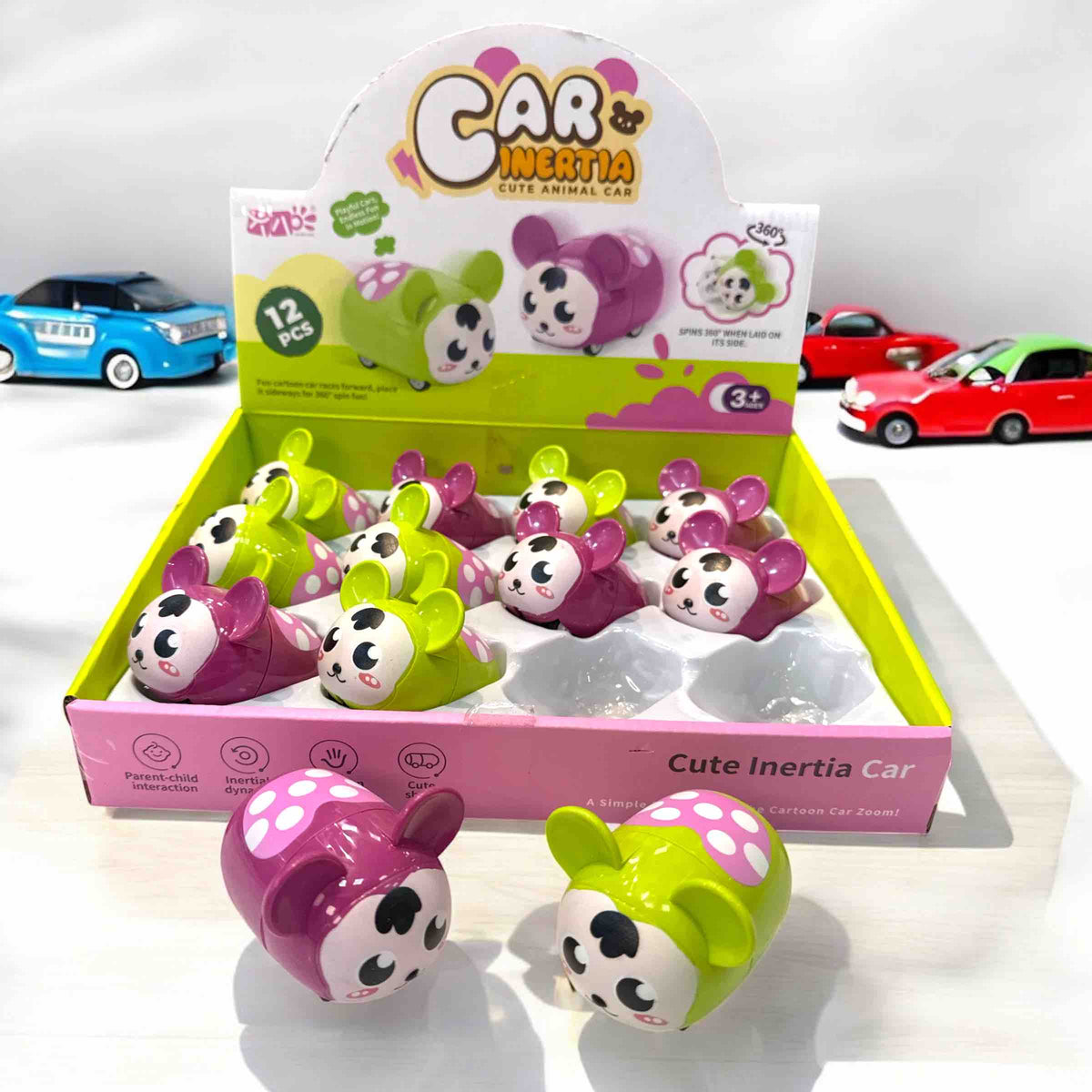 Box of 'Car Inertia' toys with panda design on a white background