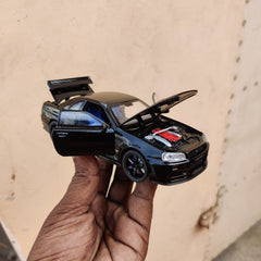 Black die-cast model of a Nissan Skyline GT-R R34 1:32 Scale Openable Doors & Light, Music Toy