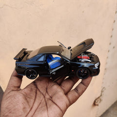 Black die-cast model of a Nissan Skyline GT-R R34 1:32 Scale Openable Doors & Light, Music Toy