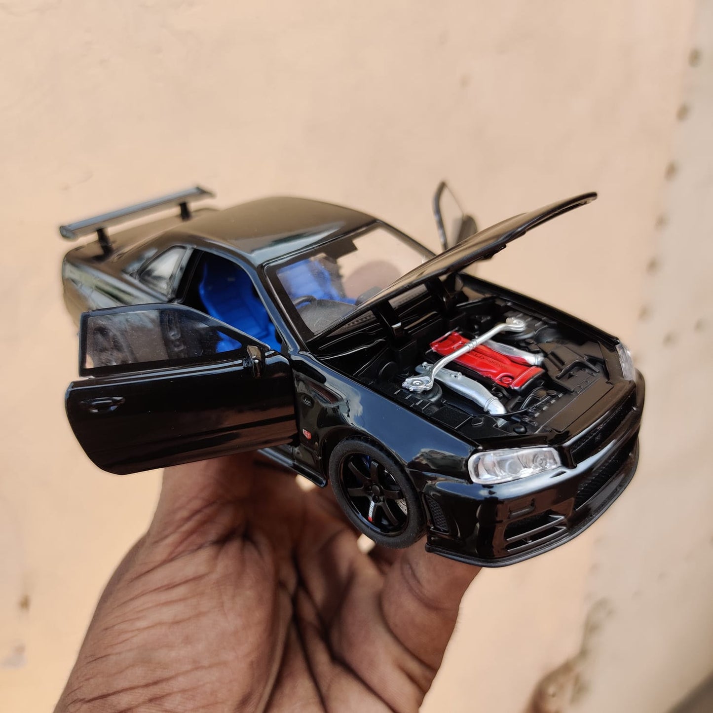 Black die-cast model of a Nissan Skyline GT-R R34 1:32 Scale Openable Doors & Light, Music Toy