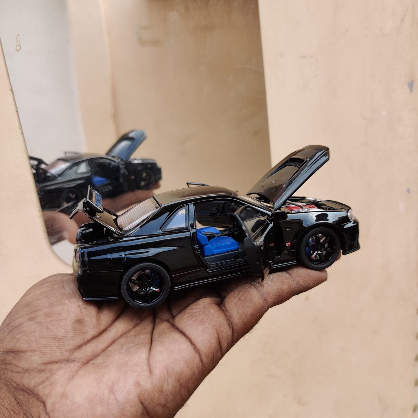 Black die-cast model of a Nissan Skyline GT-R R34 1:32 Scale Openable Doors & Light, Music Toy