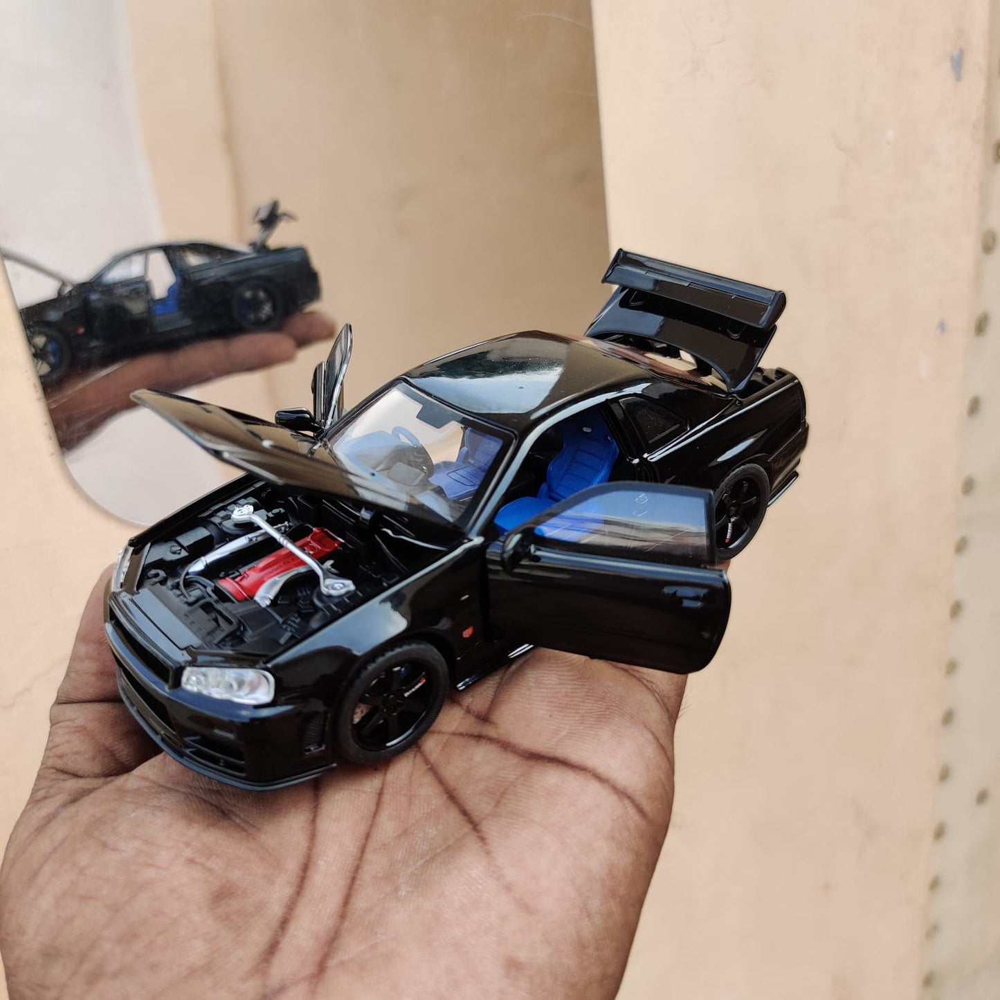 Black die-cast model of a Nissan Skyline GT-R R34 1:32 Scale Openable Doors & Light, Music Toy