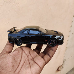 Black die-cast model of a Nissan Skyline GT-R R34 1:32 Scale Openable Doors & Light, Music Toy