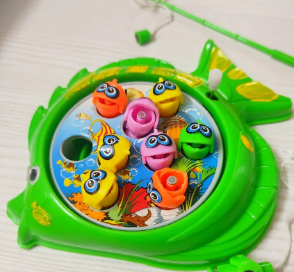 Colorful fishing game toy with various fish figures on a green base