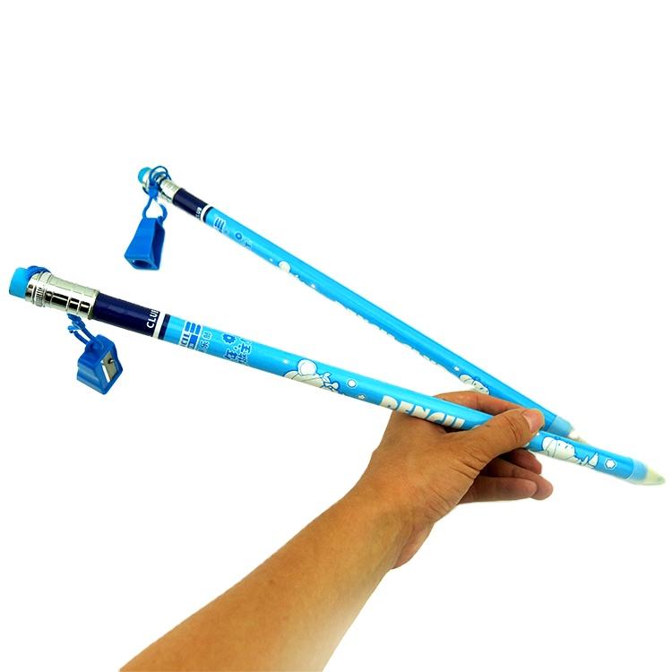 Two blue jumbo pencils with erasers held by a hand on a white background